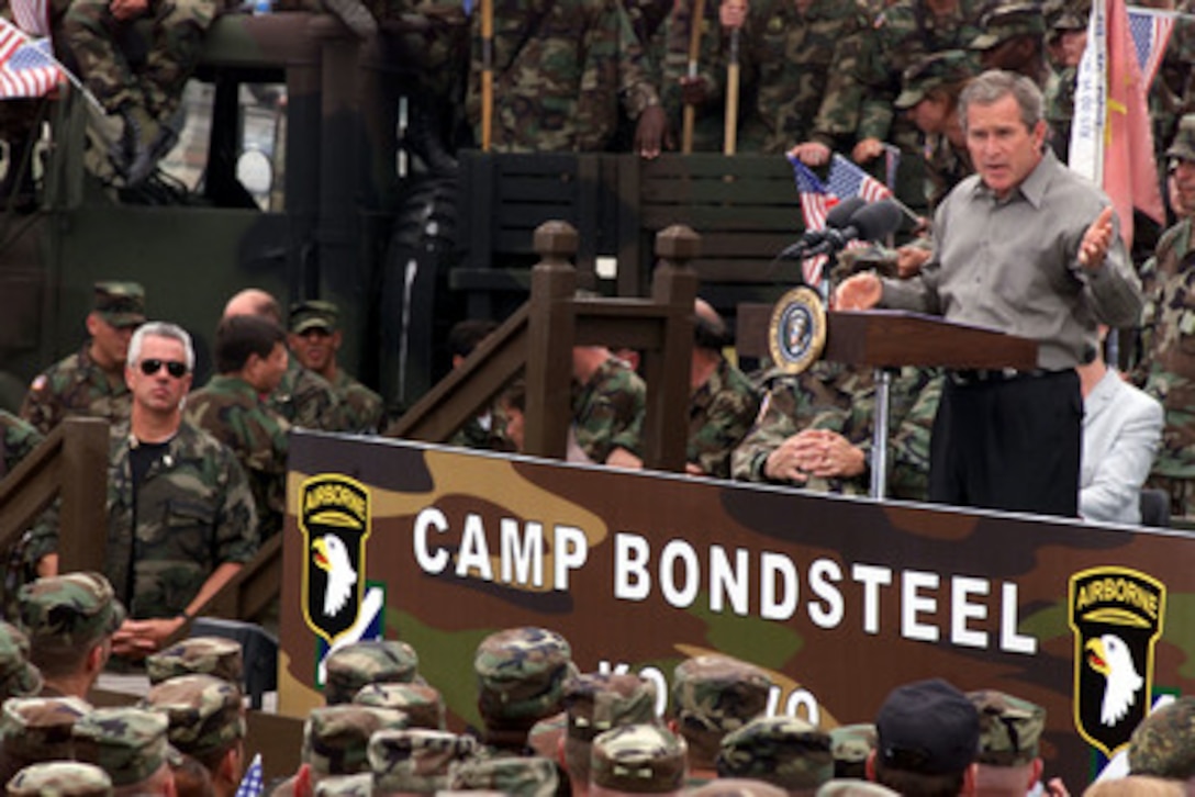 President George W. Bush speaks to U.S. soldiers and troops from other NATO nations at Camp Bondsteel in Kosovo on July 24, 2001. Bush is visiting the Task Force Falcon soldiers to show support for the troops in Kosovo. The president signed the fiscal year 2001 Emergency Supplemental Appropriations legislation which contains $1.9 billion for military pay, benefits and health care among other categories during his visit. 