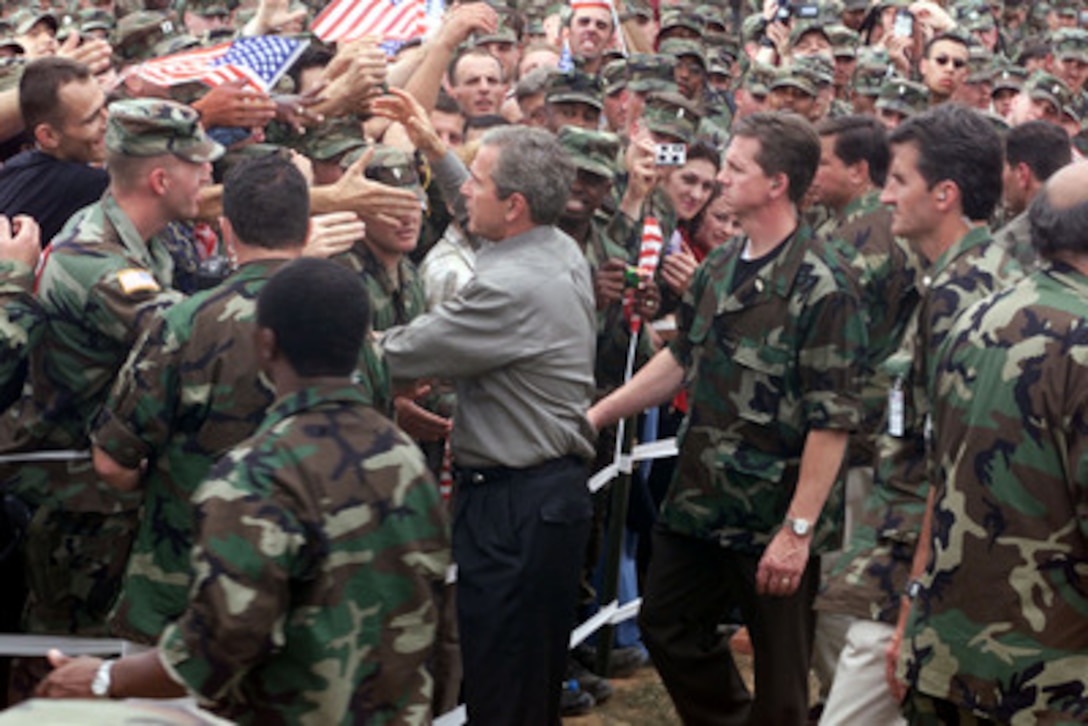 President George W. Bush shakes hands with American soldiers during his visit to Camp Bondsteel in Kosovo on July 24, 2001. Bush is visiting the Task Force Falcon soldiers to show support for the troops in Kosovo. The president signed the fiscal year 2001 Emergency Supplemental Appropriations legislation which contains $1.9 billion for military pay, benefits and health care among other categories during his visit. 