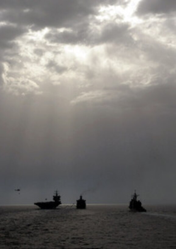 The USS Enterprise (left), USNS Sirius (center) and USS Philippine Sea steam in formation as they conduct replenishment at sea and vertical replenishment operations in the Mediterranean Sea on July 9, 2001. The Enterprise Carrier Battle Group is on a regularly scheduled, six-month deployment in the Mediterranean. 