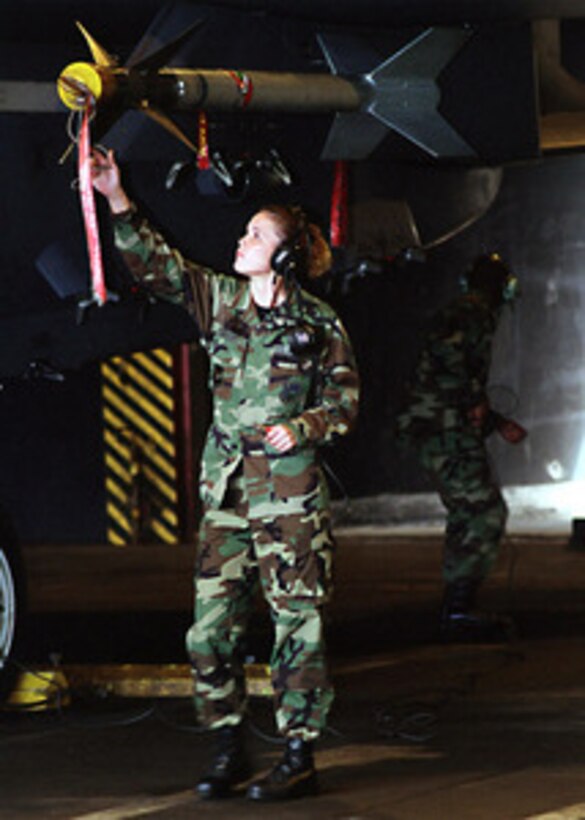 Senior Airman Tara Carson removes preflight tags from an F-15E Strike Eagle prior to engine startup at Royal Air Force Lakenheath, England, on July 20, 2001. Carson is attached to the 492nd Fighter Squadron, 48th Fighter Wing at Lakenheath. 