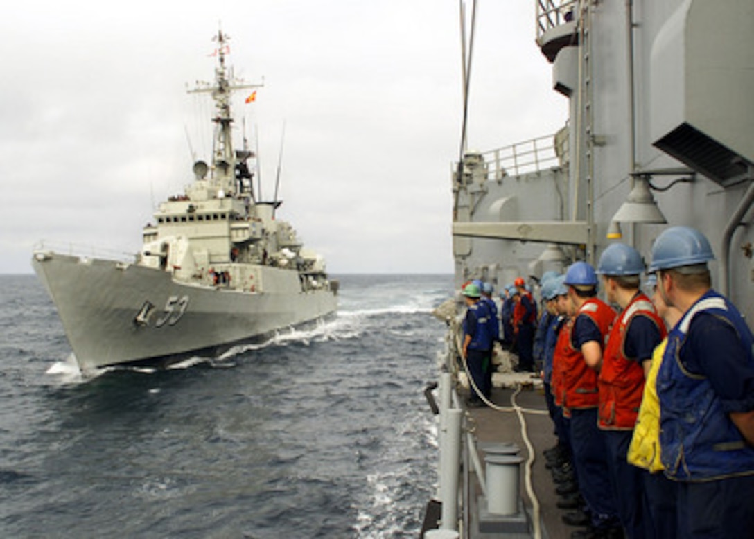 The crew of the USS Rodney M. Davis (FFG 60) stands by as the Peruvian Frigate Montero (FM 53) comes alongside to conduct a light-line transfer during Silent Force Exercise in the Pacific Ocean on July 26, 2001. The Montero and the Davis, along with two other U.S. warships, are engaged in five days of undersea exercises with four Peruvian diesel submarines off the coast of Lima, Peru. 