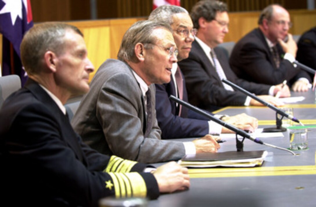 Secretary of Defense Donald H. Rumsfeld (second from left) answers a question during a press conference at the conclusion of the Australia-U.S. Ministerial talks at Parliament House, Canberra, Australia, on July 30, 2001. Rumsfeld, Secretary of State Colin Powell (center) and U.S. Pacific Command Commander in Chief Adm. Dennis Blair (left), U.S. Navy, met with Australian Minister for Foreign Affairs Alexander Downer and Minister of Defence Peter Reith for talks to further advance the Australia-United States alliance relationship. 