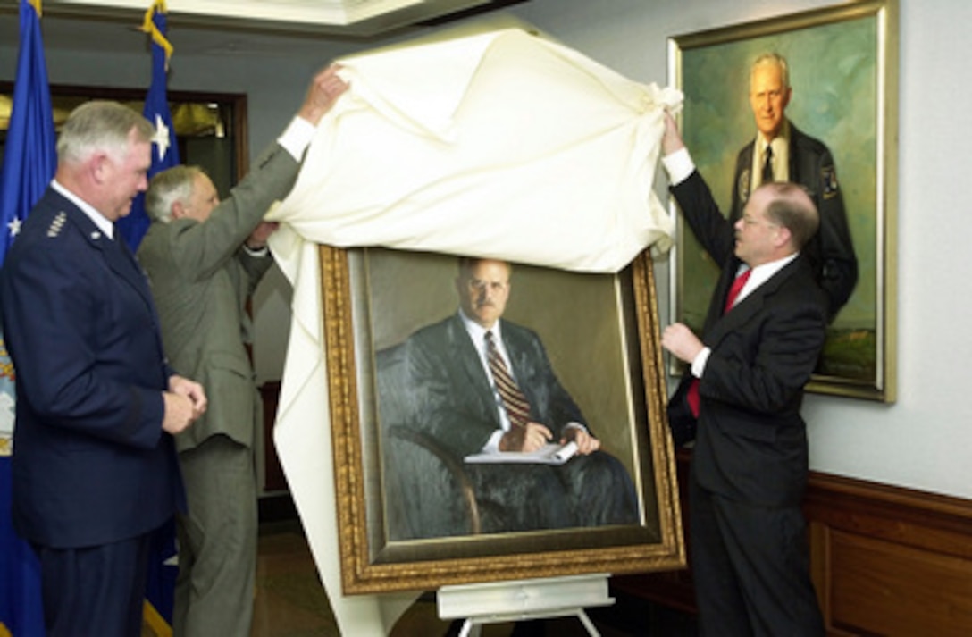 Former Secretary of the Air Force F. Whitten Peters (right) and portrait artist Peter Egeli (center) unveil Peters' official portrait during a ceremony at the Pentagon, on May 14, 2001. The painting will join the portraits of all former Air Force secretaries hanging in the E-ring of the Pentagon. Peters was the secretary of the Air Force from July 30, 1999, to Jan. 20, 2001. Chief of Staff of the Air Force Gen. Michael E. Ryan (left) joined the Peters and Egeli in the unveiling ceremony. 