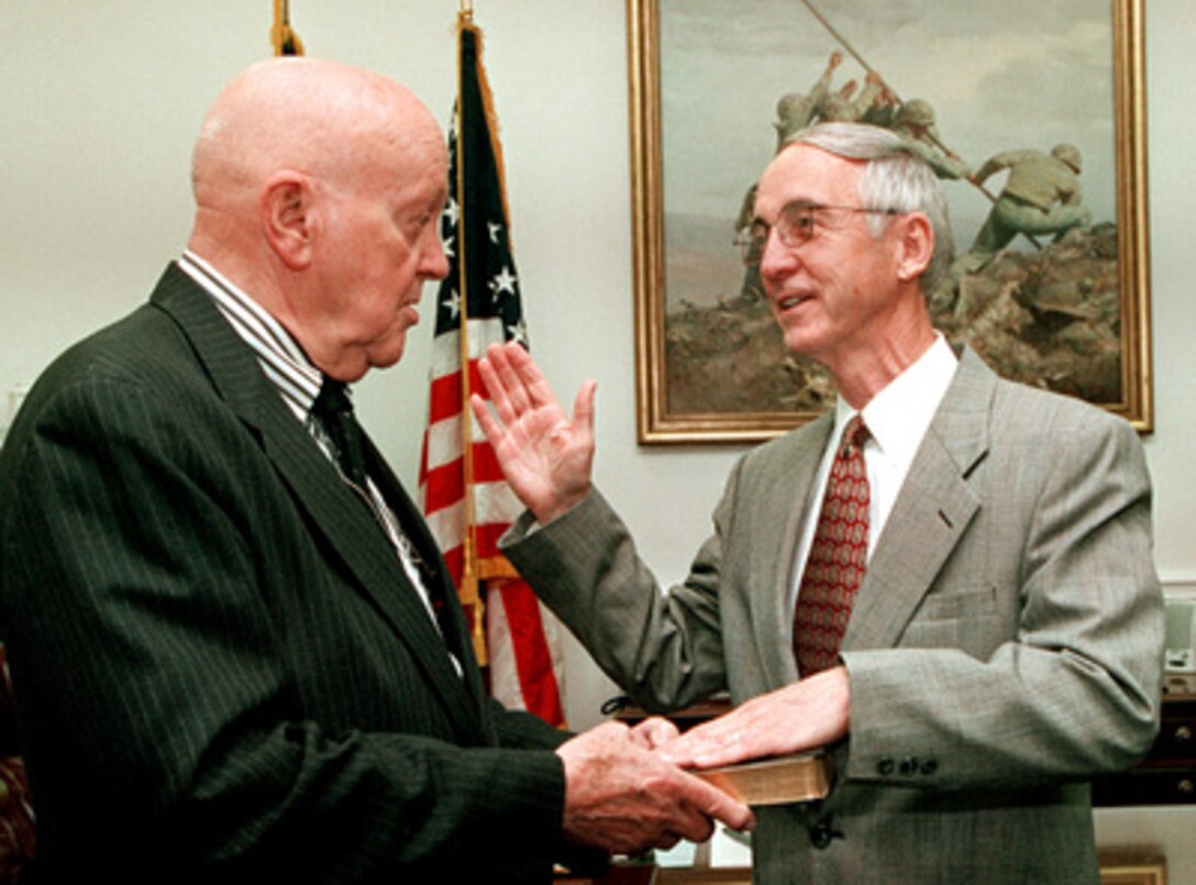 Gordon R. England (right) is administered the oath of office as the 72nd Secretary of the Navy by David O. Cooke in the Pentagon on May 24, 2001. England was nominated by President George W. Bush to be secretary of the navy on April 24, 2001, and was confirmed by the Senate on May 22, 2001. Cooke is the director of administration and management for Office of the Secretary of Defense. 