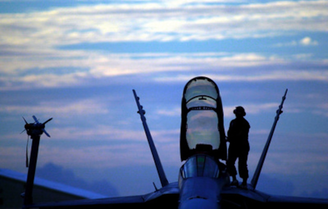 Gunnery Sgt. Rome M. Holcomb conducts post flight checks on an F/A-18 Hornet at Rockhampton Airport, Australia, on April 29, 2001. The Hornet will participate in Exercise Tandem Thrust 2001, which is a combined military training exercise involving more than 18,000 U.S., Australian, and Canadian personnel who are training in crisis action planning and execution of contingency response operations. 