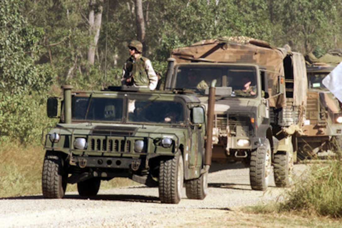 U.S. Marines convoy with Australian forces to new locations along the North/South route through Shoalwater Bay Training Area, Queensland, Australia, on May 7, 2001 during Exercise Tandem Thrust 2001. Tandem Thrust is a combined military training exercise involving more than 18,000 U.S., Australian, and Canadian personnel who are training in crisis action planning and execution of contingency response operations. 