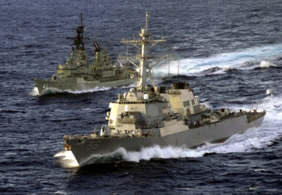 HMAS Brisbane (DDG 41) and USS John S. McCain (DDG 56) cruise side by side in Australian waters supporting operations during Exercise Tandem Thrust 2001 on May 19, 2001. Tandem Thrust is a combined military training exercise involving more than 18,000 U.S., Australian, and Canadian personnel who are training in crisis action planning and execution of contingency response operations. 