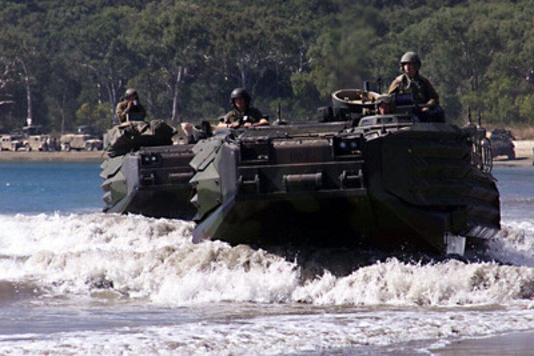 Amphibious Assault Vehicles from the 31st Marine Expeditionary Unit, move across Freshwater Beach at the Shoalwater Bay Training Area, Queensland, Australia, on May 25, 2001, prior to being back-loaded during Exercise Tandem Thrust 2001. Tandem Thrust is a combined military training exercise involving more than 18,000 U.S., Australian, and Canadian personnel who are training in crisis action planning and execution of contingency response operations. 