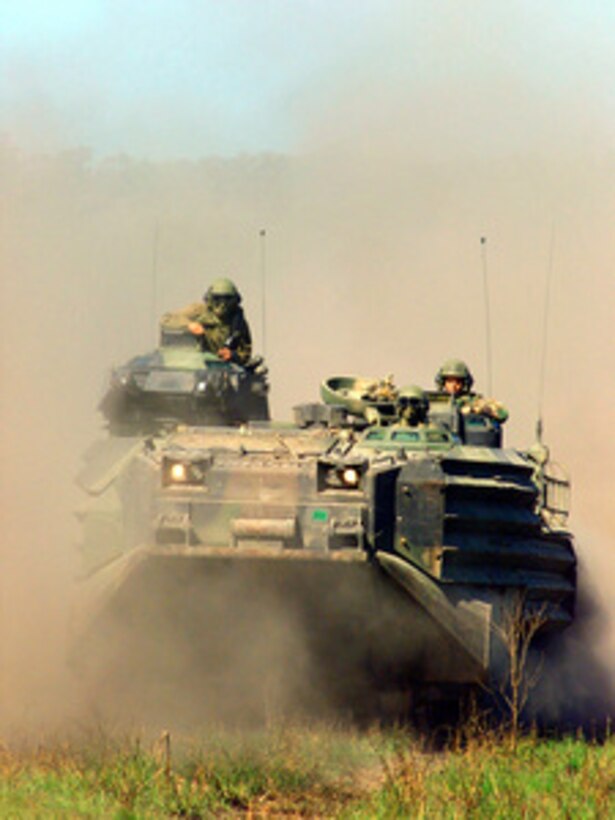 A Marine maneuvers his assault vehicle during a live fire exercise on May 25, 2001, at Shoalwater Bay Military Training Area, Queensland, Australia, during Exercise Tandem Thrust 2001. Tandem Thrust is a combined military training exercise involving more than 18,000 U.S., Australian, and Canadian personnel who are training in crisis action planning and execution of contingency response operations. 