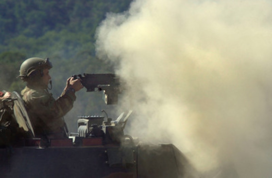 A Marine is almost engulfed with a cloud of smoke from his weapon during a live fire exercise on May 25, 2001 at Shoalwater Bay Training Area, Queensland, Australia, for Exercise Tandem Thrust 2001. This Marine from the 4th Light Armored Reconnaissance Battalion, of Quantico, Va., is part of the combined military training exercise involving more than 18,000 U.S., Australian, and Canadian personnel who are training in crisis action planning and execution of contingency response operations. 