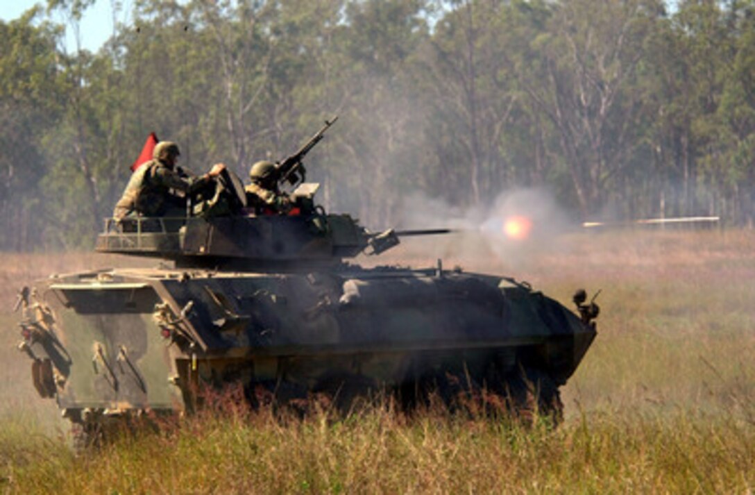 Marines commence a live fire exercise with a Light Armored Vehicle for Exercise Tandem Thrust 2001 at Schoalwater Bay Training Area, Queensland, Australia, on May 25, 2001. Tandem Thrust is a combined military training exercise involving more than 18,000 U.S., Australian, and Canadian personnel who are training in crisis action planning and execution of contingency response operations. These Marines are part of the 4th Light Armored Reconnaissance Battalion, deployed from Quantico, Va.. 