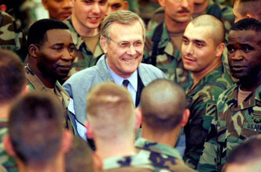 Secretary of Defense Donald H. Rumsfeld is surrounded by soldiers of Task Force Falcon as he poses for pictures and talks with them in the theater at Camp Bondsteel, Kosovo, on June 5, 2001. Rumsfeld is in Europe to visit U.S. forces in the region and to consult with his counterparts and senior government officials. Rumsfeld will later attend the Southeast European Defense Ministerial in Thessaloniki, Greece. The troops are deployed to Kosovo in support of KFOR, which is the NATO-led international military force in Kosovo on the peacekeeping mission known as Operation Joint Guardian. 