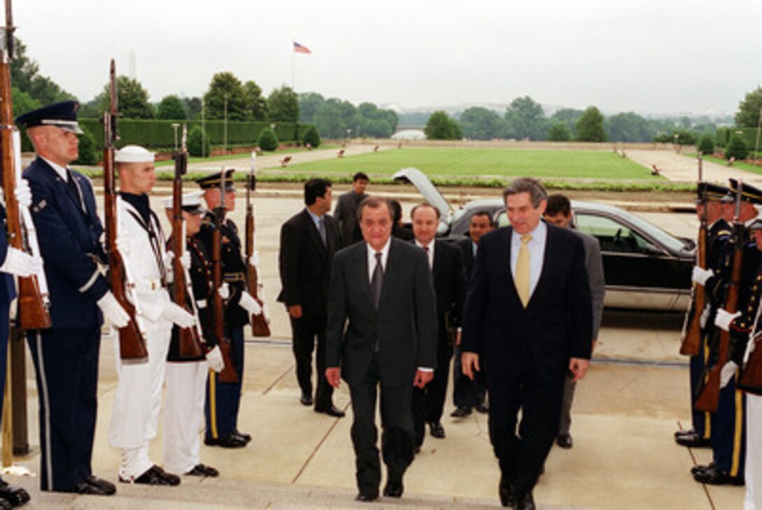 Deputy Secretary of Defense Paul Wolfowitz (right) escorts Minister of Foreign Affairs Abdulaziz Kamilov (left), of Uzbekistan, into the Pentagon on June 7, 2001. 