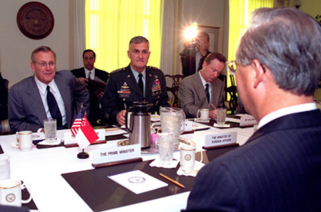 Secretary of Defense Donald H. Rumsfeld (left), Chairman of the Joint Chiefs of Staff Gen. Henry H. Shelton (center), U.S. Army, and Special Assistant to the Secretary for Policy Daniel Gallington meet with Prime Minister Goh Chok Tong (right foreground) of Singapore at the Pentagon on June 14, 2001. Rumsfeld, Shelton and Goh are discussing a range of policy and security issues of interest to both nations. 