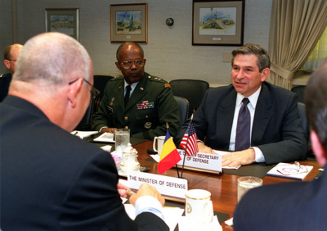 Deputy Secretary of Defense Paul Wolfowitz (right) meets with Romanian Minister of Defense Ioan Mircea Pascu (foreground) at the Pentagon on June 13, 2001. A range of regional security issues of interest to both nations are under discussion. Joining Wolfowitz at the conference table is Maj. Gen. Gregory Roundtree (center), principal director of European and NATO affairs for the Department of Defense. 