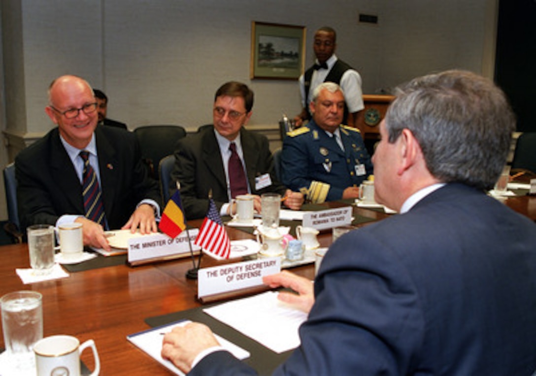 Romanian Minister of Defense Ioan Mircea Pascu (left) meets with Deputy Secretary of Defense Paul Wolfowitz (right foreground) at the Pentagon on June 13, 2001. A range of regional security issues of interest to both nations are under discussion. Joining Pascu are (left to right) Bogdan Nazuru, Romania's ambassador to NATO, and Maj. Gen. Constantin Gheorghe, deputy chief of the Romanian General Staff. 