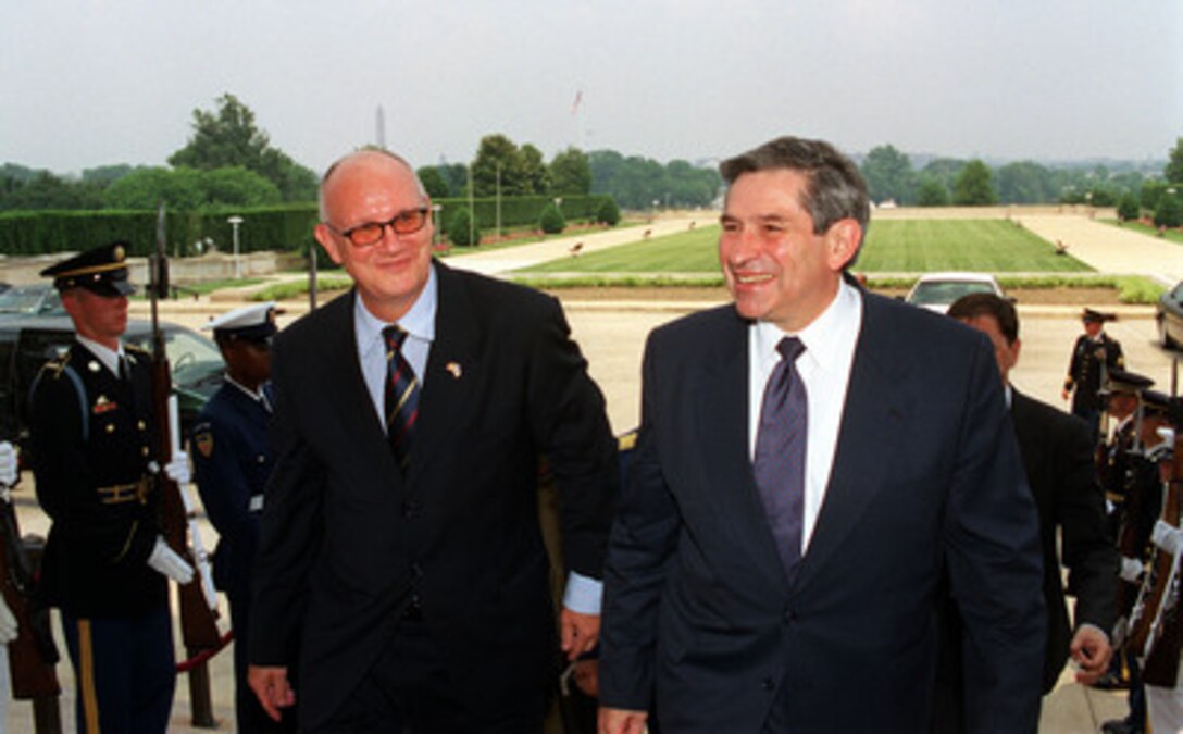 Romanian Minister of Defense Ioan Mircea Pascu (left) is escorted into the Pentagon by Deputy Secretary of Defense Paul Wolfowitz on June 13, 2001. Pascu and Wolfowitz will meet to discuss a range of regional security issues of interest to both nations. 