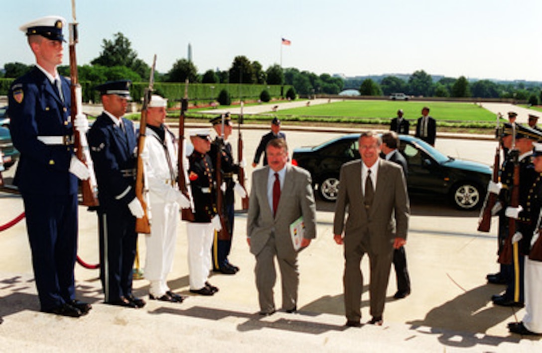 Secretary of Defense Donald H. Rumsfeld (right) escorts Minister of Defense Andre Flahaut (left), of Belgium, into the Pentagon on June 18, 2001. Rumsfeld and Flahaut will meet to discuss a range of regional security issues of interest to both nations. 