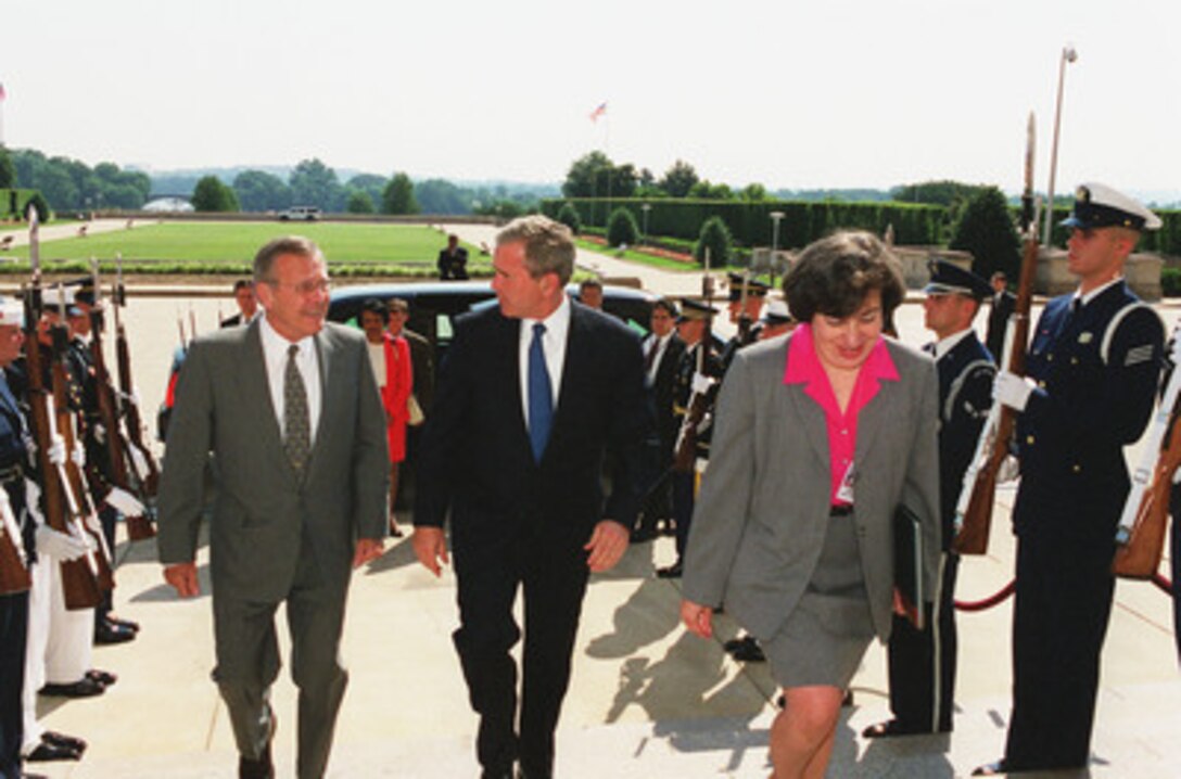 Secretary of Defense Donald H. Rumsfeld (left), accompanied by Dinah Cohen (right), Director of CAPTEC, escorts President George W. Bush into the Pentagon June 19, 2001. Bush is visiting the Computer/Electronic Accommodations Program Technology Evaluation Center (CAPTEC), and will address Department of Defense personnel. CAPTEC provides assistive technology, such as adaptive computers, electronic equipment and devices specially designed to meet the needs of employees with disabilities. 