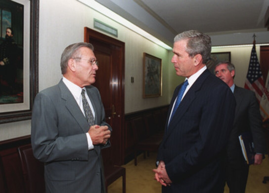 Secretary of Defense Donald H. Rumsfeld (left) chats with President George W. Bush in the Joint Chiefs of Staff conference room, more commonly known as the tank, June 19, 2001. Bush is in the Pentagon to visit the Computer/Electronic Accommodations Program Technology Evaluation Center (CAPTEC), and will address Department of Defense personnel. CAPTEC provides assistive technology, such as adaptive computers, electronic equipment and devices specially designed to meet the needs of employees with disabilities. 