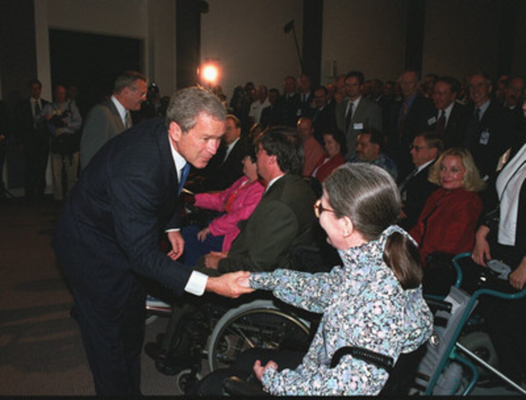 President George W. Bush greets Pentagon employee Judy Gilliom following his address to Department of Defense personnel at the Pentagon on June 19, 2001. President Bush stressed his continued support for employment and accessibility for persons with disabilities. Bush visited the Pentagon Computer/Electronic Accommodations Program Technology Evaluation Center (CAPTEC) which ensures people with disabilities have equal access to the information environment and opportunities in the Federal Government. 