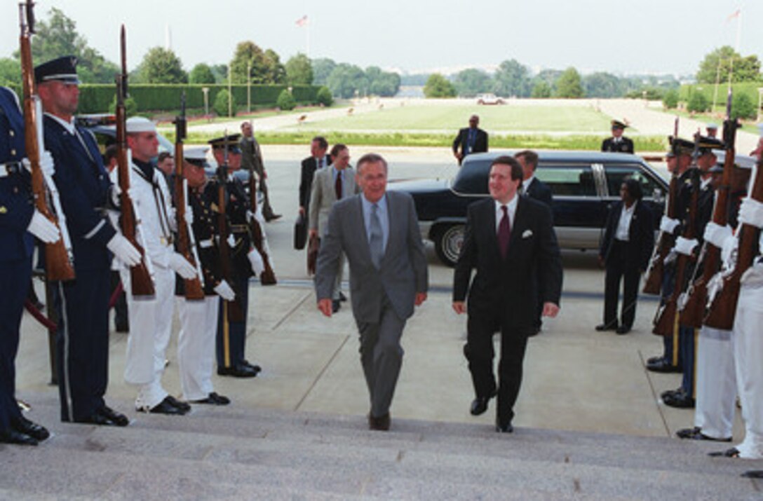 Secretary of Defense Donald H. Rumsfeld (left) escorts NATO Secretary General Lord George Robertson into the Pentagon on June 20, 2001. Rumsfeld and Robertson will meet to discuss a range of regional security issues. 