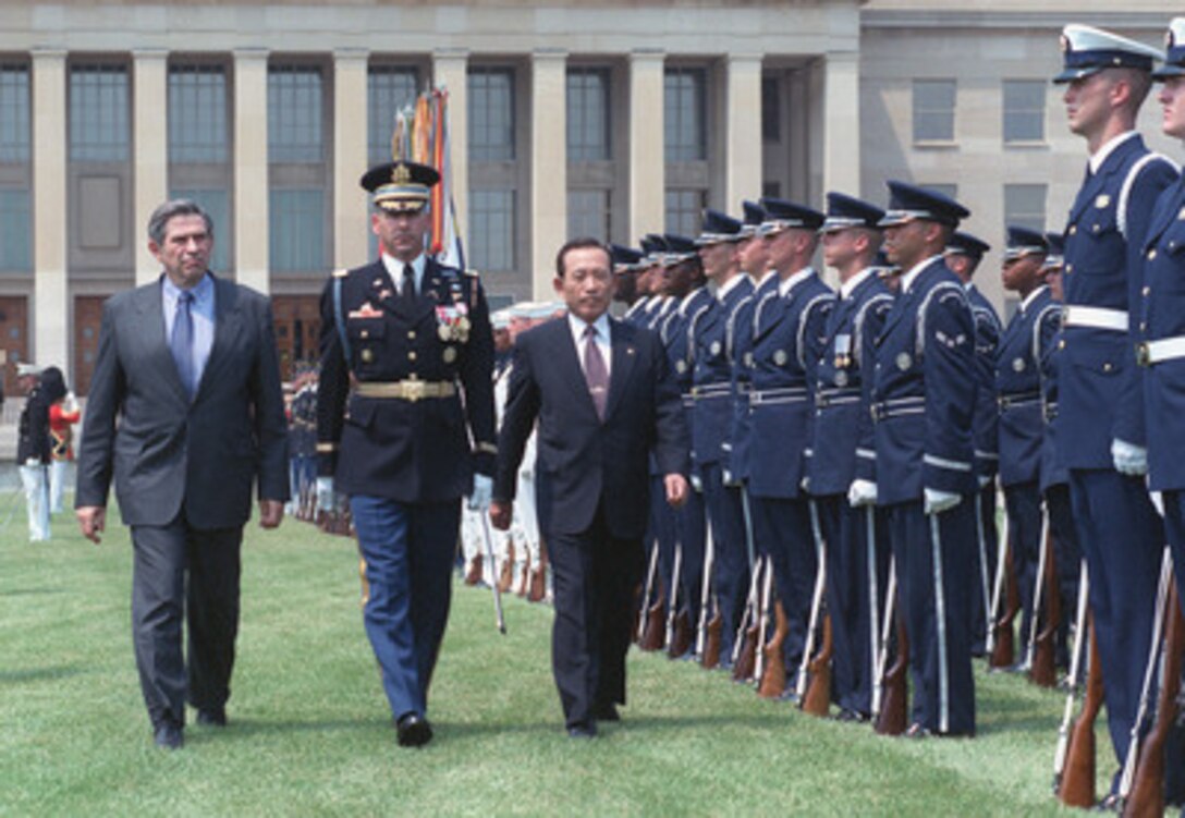 Minister of Defense Kim Dong-Shin (right), of the Republic of Korea, inspects the joint services honor guard during ceremonies, hosted by Deputy Secretary of Defense Paul Wolfowitz (left), welcoming him to the Pentagon, June 21, 2001. Accompanying the two defense leaders is Col. James F. Laufenberg (center), U.S. Army, the commander of troops for the event. Following the ceremonies, Kim met with Secretary of Defense Donald Rumsfeld, Deputy Secretary Wolfowitz, and Gen. Henry H. Shelton, chairman of the Joint Chiefs of Staff, among other high-level DoD officials, at a working luncheon. 