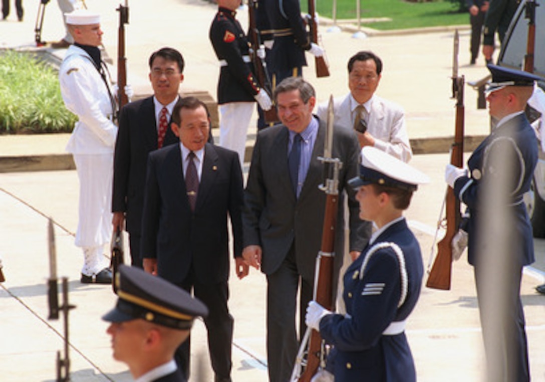 Deputy Secretary of Defense Paul Wolfowitz (right) escorts South Korean Minister of Defense Kim Dong-Shin into the Pentagon at the conclusion of a full honor military arrival ceremony he hosted to honor Kim's visit. Later both men will join Secretary of Defense Donald H. Rumsfeld and Gen. Henry H. Shelton, U.S. Army, chairman of the Joint Chiefs of Staff, and other high-level DoD officials, for a working lunch. 