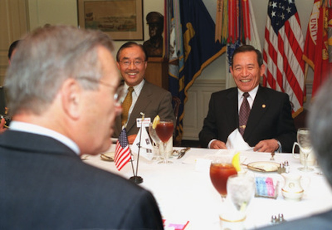 Minister of Defense Kim Dong-Shin (right), of the Republic of Korea, was the guest of honor at a working luncheon hosted at the Pentagon, June 21, 2001, by Secretary of Defense Donald H. Rumsfeld (left foreground). A range of regional security issues were scheduled for discussion. Among those joining Kim was South Korea's Ambassador to the United States Yang Sung-Chul (center). 