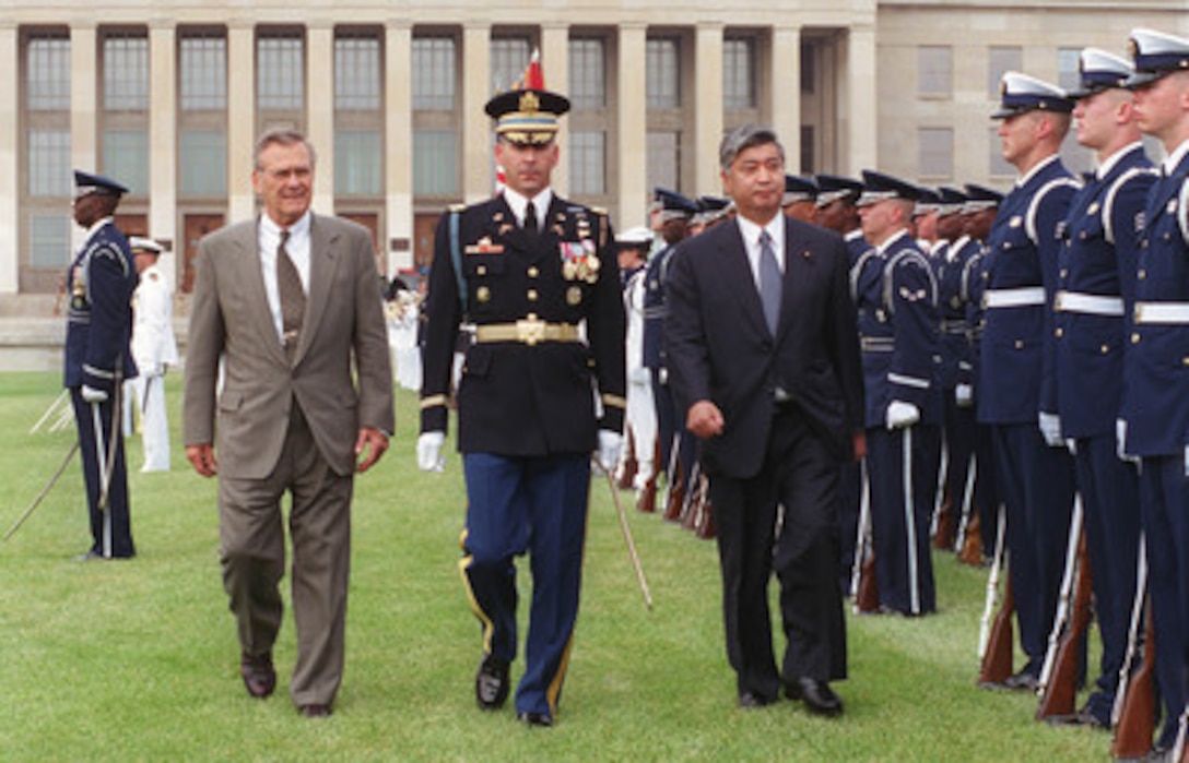 Secretary of Defense Donald H. Rumsfeld (left) accompanies his guest Gen Nakatani (right), director general of the Japan Defense Agency, as he inspects the joint services honor guard at the Pentagon, June 22, 2001. Following the full honor arrival ceremony, the two defense leaders are scheduled to meet for discussions of a range of regional and global security issues of interest to both nations. 