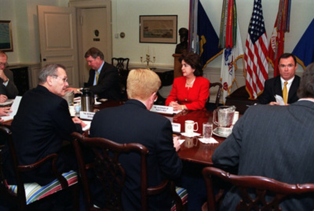 Secretary of Defense Donald H. Rumsfeld (left) welcomes Puerto Rican Governor Sila Calderon (center) and her delegation to a formal meeting in the Pentagon on Feb. 27, 2001. Rumsfeld and Calderon are meeting with Rumsfeld to discuss the issue of Navy training on Vieques Island. 