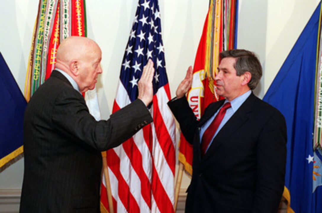 David O. "Doc" Cooke (left) administers the oath of office to Paul Wolfowitz as the 28th Deputy Secretary of Defense in a Pentagon ceremony on March 2, 2001. Cooke is the director of Administration and Management, Office of the Secretary of Defense. 
