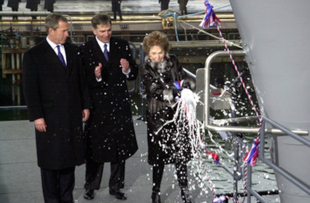 Former First Lady Nancy Reagan smashes the traditional bottle of champagne on the bow as she christens the U.S. Navy's newest aircraft carrier Ronald Reagan (CVN 76) on March 4, 2001, in Newport News, Va. President George W. Bush and Chairman and Chief Executive Officer of Newport News Shipbuilding William P. Frick joined Reagan in the ceremony. The nuclear powered ship, named in honor of the 40th president, is being built at Newport News Shipbuilding. 