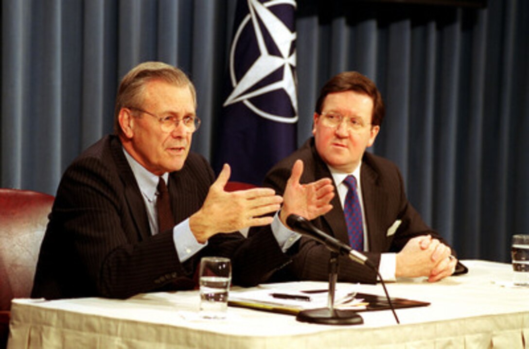 Secretary of Defense Donald H. Rumsfeld (left) responds to a reporter's question during a joint press conference with NATO Secretary General Lord George Robertson at the Pentagon on March 8, 2001. 