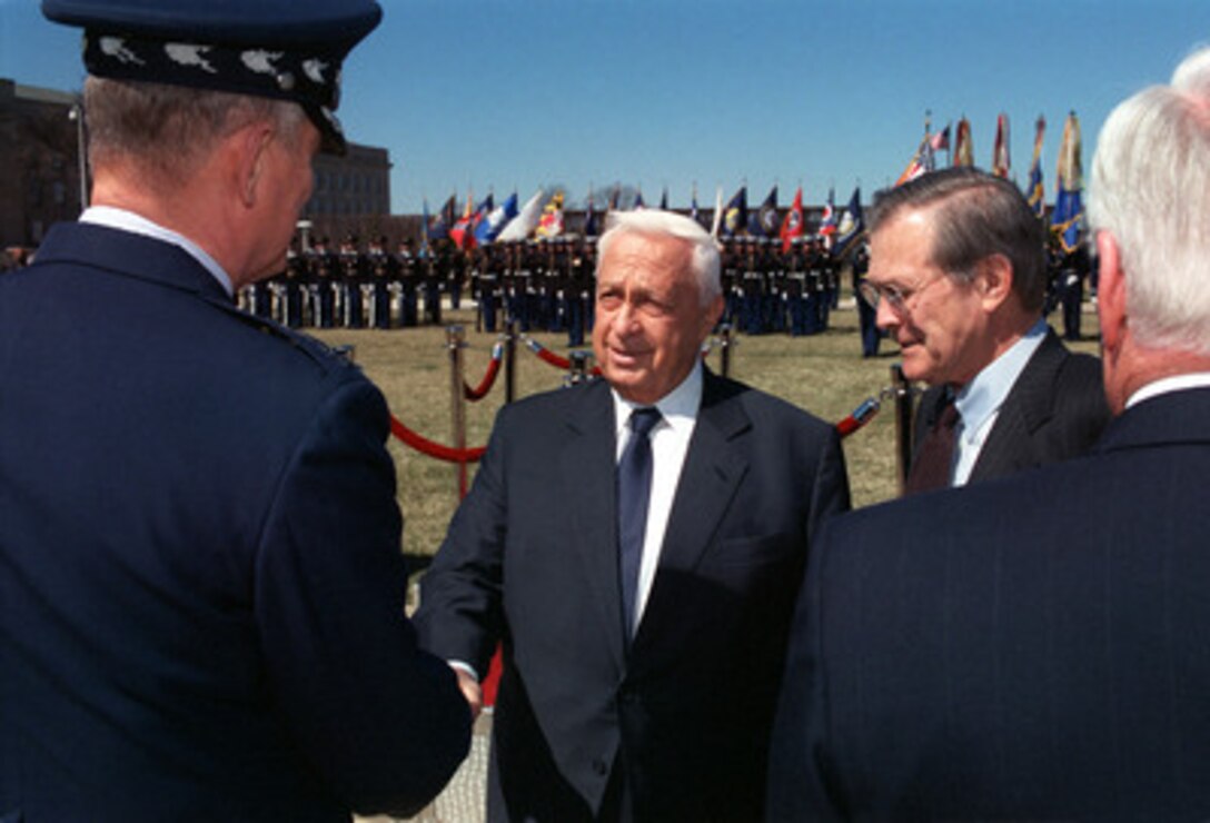 Secretary of Defense Donald H. Rumsfeld (right) introduces Vice Chairman of the Joint Chiefs of Staff Gen. Richard Myers (left), U.S. Air Force, to Israeli Prime Minister Ariel Sharon (center) after an arrival ceremony for Sharon at the Pentagon on March 19, 2001. Rumsfeld and Sharon will meet to discuss regional and international security issues of interest to both nations. 