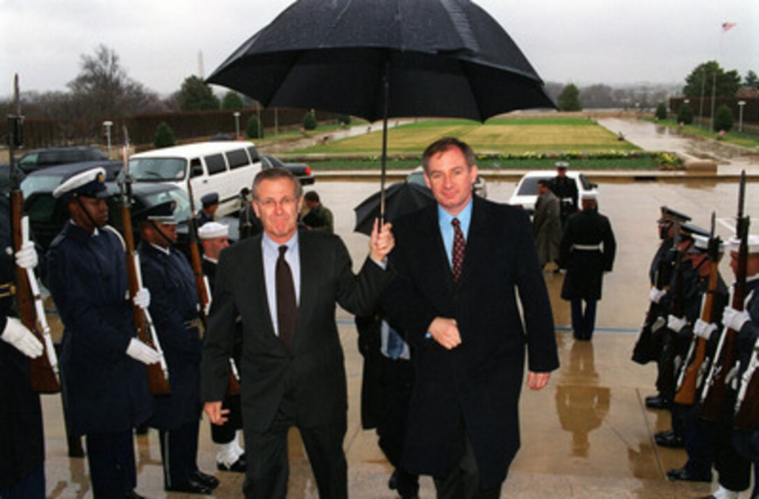 Secretary of Defense Donald H. Rumsfeld (left), escorts the United Kingdom's Secretary of State for Defence Geoffrey Hoon (right) into the Pentagon on March 21, 2001. Rumsfeld and Hoon will hold bilateral security talks. 