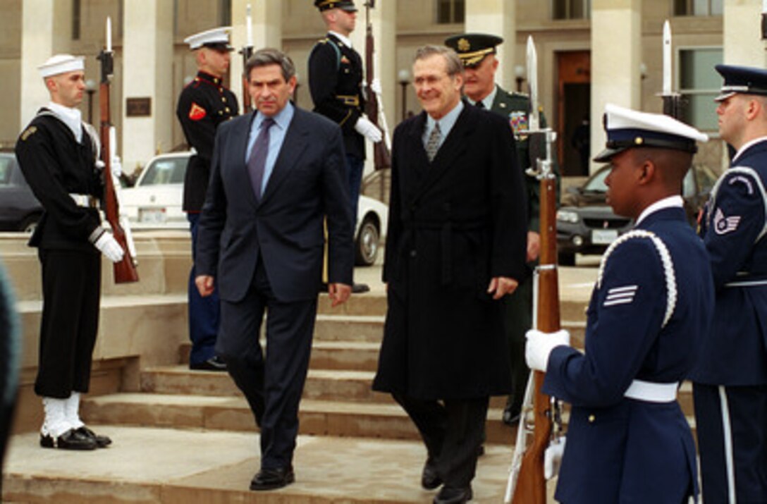 Secretary of Defense Donald H. Rumsfeld (right) escorts Deputy Secretary of Defense Paul Wolfowitz (left) to his armed forces welcoming ceremony at the Pentagon on March 16, 2001. Wolfowitz is the 28th deputy secretary of Defense. Chairman of the Joint Chiefs of Staff Gen. Henry H. Shelton, U.S. Army, walks to the parade field with the two men. 