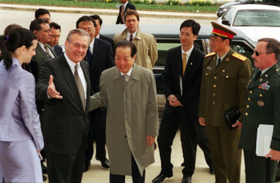 Secretary of Defense Donald H. Rumsfeld (left) welcomes Vice Premier Qian Qichen (center), of the Peoples Republic of China, as he arrives at the Pentagon on March 22, 2001. Rumsfeld and Qian will meet to discuss a range of security issues of interest to both nations. 