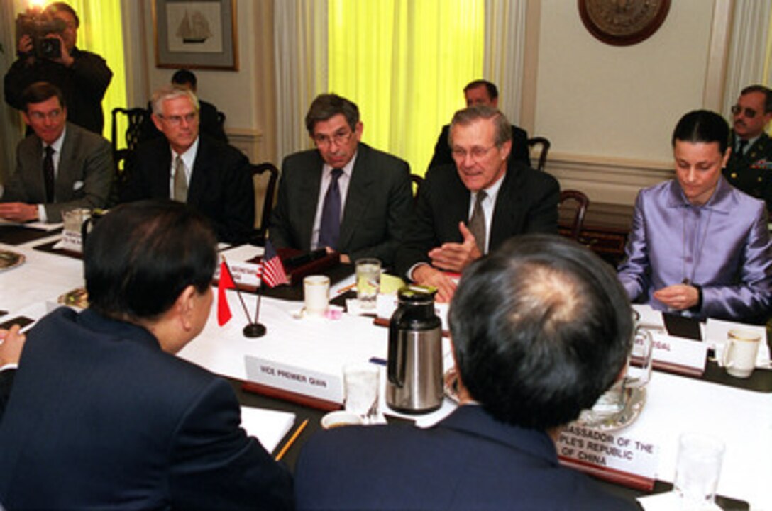 Secretary of Defense Donald H. Rumsfeld (second from right, far-side) hosts a meeting with Vice Premier Qian Qichen (left, foreground), of the Peoples Republic of China, at the Pentagon on March 22, 2001. Among those participating in the talks are from left to right: Deputy Assistant Secretary of Defense for Asia Pacific Affairs Fred Smith, U.S. ambassador to the Peoples Republic of China Joseph Prueher, Deputy Secretary of Defense Paul Wolfowitz, Rumsfeld, and the interpreter Vicki Segal. 