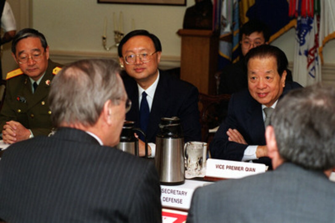 Secretary of Defense Donald H. Rumsfeld (left foreground) and Deputy Secretary of Defense Paul Wolfowitz (right foreground) meet with Vice Premier Qian Qichen (right, far-side), of the Peoples Republic of China, at the Pentagon on March 22, 2001. Among those participating in the talks were Maj. Gen. Gong Xianfu (left), defense attaché, and Ambassador Yang Jiechi (center). 