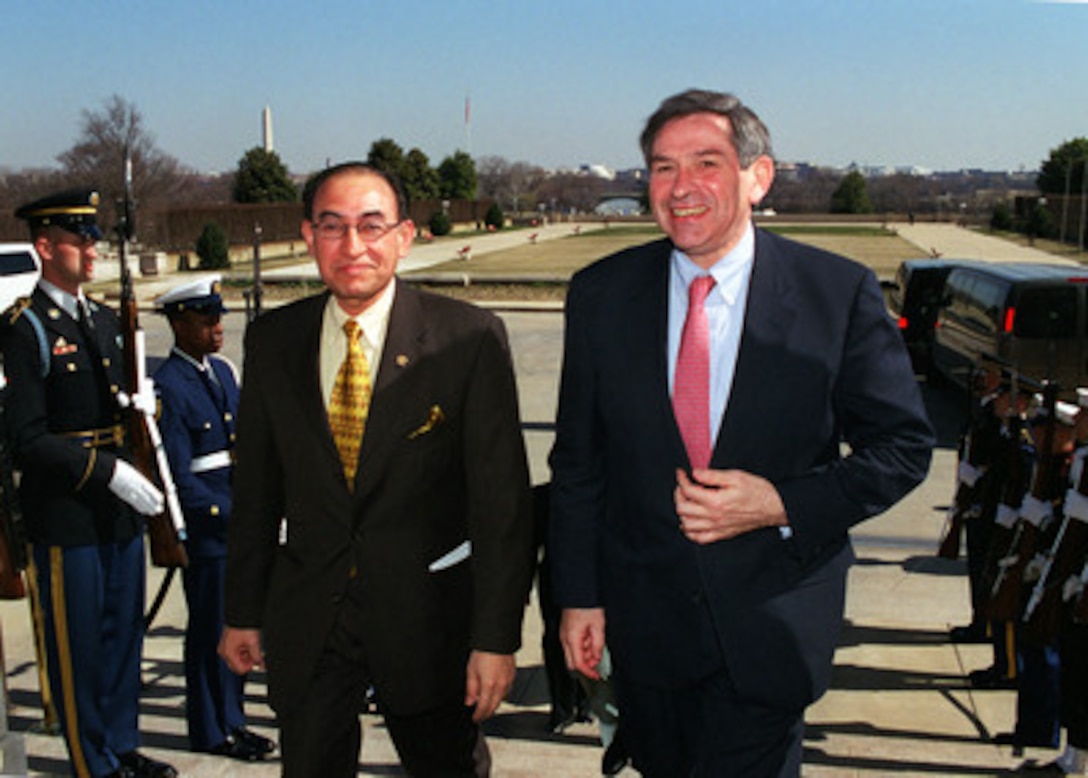 Indonesian Minister of Foreign Affairs Alwi Abdurrahman Shihab (left) is escorted through an honor cordon and into the Pentagon by Deputy Secretary of Defense Paul Wolfowitz on March 12, 2001. Shihab and Wolfowitz are meeting to discuss regional security issues of interest to both nations. 