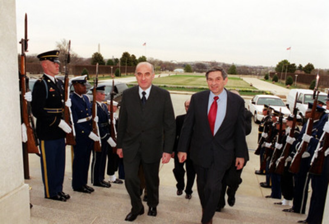 Minister of Foreign Affairs of the Republic of Georgia Irakli Menagharishvili (left) is escorted through an honor cordon and into the Pentagon by Deputy Secretary of Defense Paul Wolfowitz on March 20, 2001. Menagharishvili and Wolfowitz will meet to discuss regional security issues of interest to both nations. 