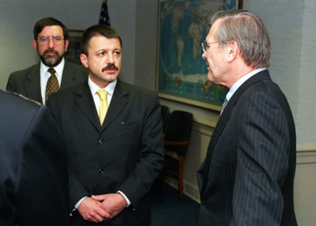 Secretary of Defense Donald H. Rumsfeld (right) talks with Bulgarian Minister of Defense Boyko Noev (center) during bilateral security talks at the Pentagon on March 26, 2001. Bulgarian Ambassador to the United States Phillip Dimitrov joined Rumsfeld and Noev in the discussion. 