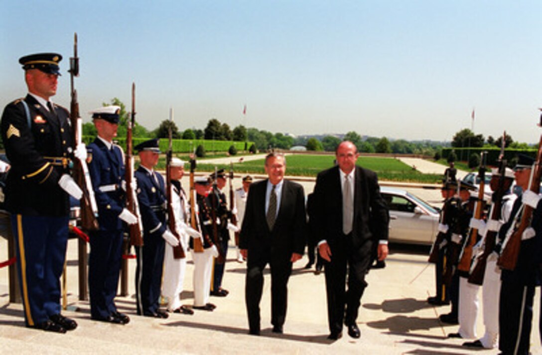 Secretary of Defense Donald H. Rumsfeld (left) escorts Australian Minister for Defense Peter Reith (right) through an honor cordon and into the Pentagon on May 1, 2001. Rumsfeld and Reith will meet to discuss a range of regional policy and security issues of interest to both nations. 