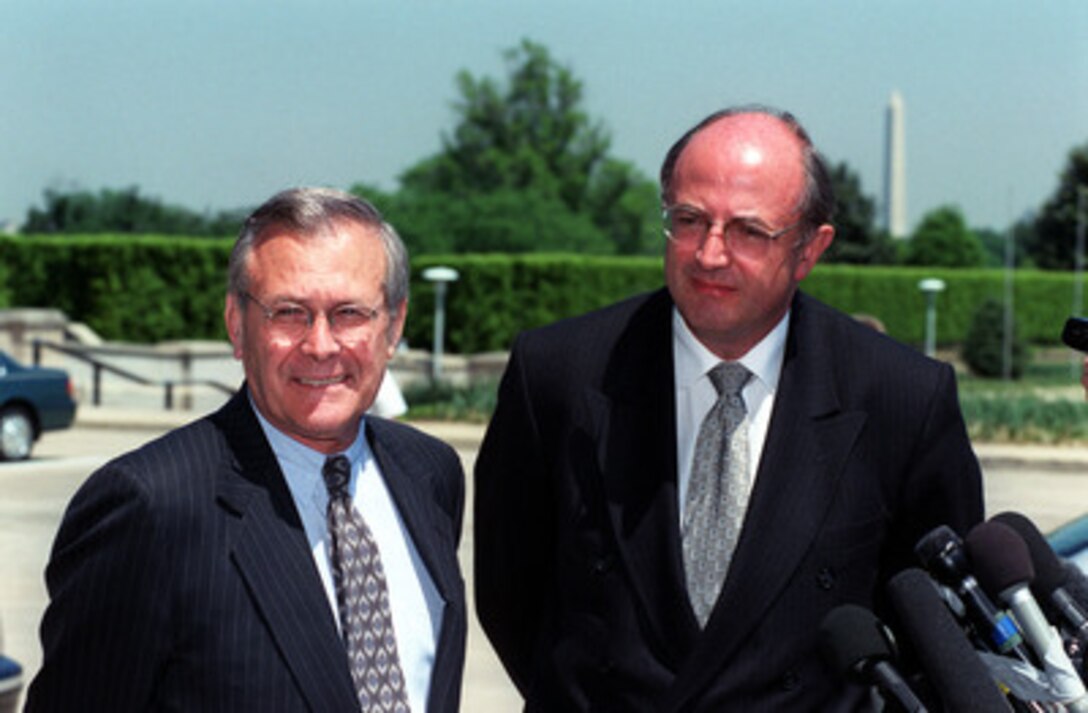 Secretary of Defense Donald H. Rumsfeld (left) and Australian Minister for Defense Peter Reith (right) listen to a reporter's question during a media availability at the Pentagon on May 1, 2001. Rumsfeld and Reith had just concluded their meeting where they discussed a range of regional policy and security issues of interest to both nations. 