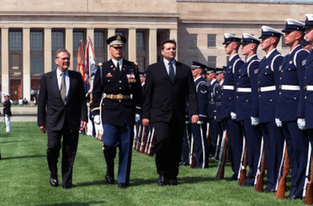 President Boris Trajkovski (right), of the Former Yugoslav Republic of Macedonia, is escorted by Commander of Troops Col. Thomas M. Jordan (center), U.S. Army, and Secretary of Defense Donald H. Rumsfeld (left) as he inspects the ceremonial honor guard at the Pentagon on May 2, 2001. Trajkovski and Rumsfeld will meet later to discuss regional security issues of concern to both nations. 