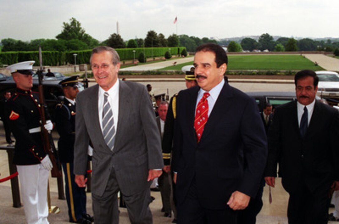 Secretary of Defense Donald H. Rumsfeld (left) escorts His Highness Hamad bin Isa Al-Khalifa (right), the amir of Bahrain, into the Pentagon on May 8, 2001. Rumsfeld and the Amir will later meet to discuss regional security issues of interest to both nations. 