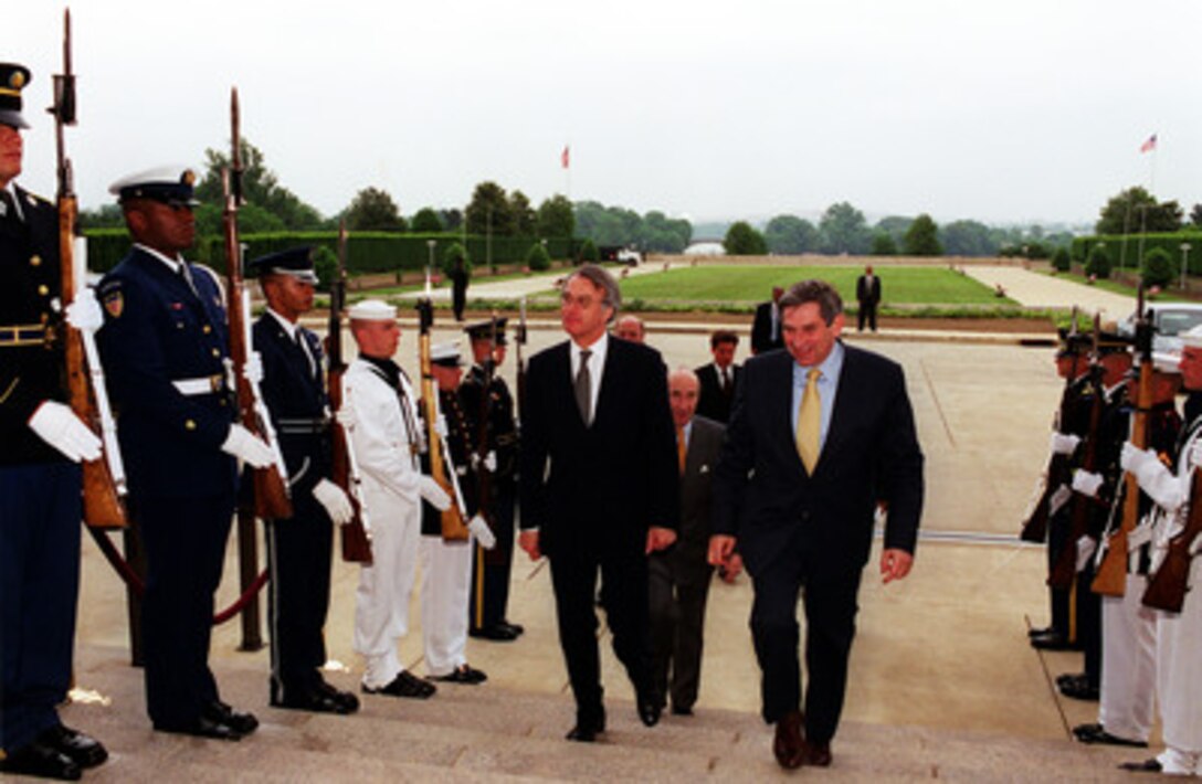 Foreign Minister Jozias van Aartsen (left) of the Netherlands is escorted into the Pentagon by Deputy Secretary of Defense Paul Wolfowitz May 18, 2001. 