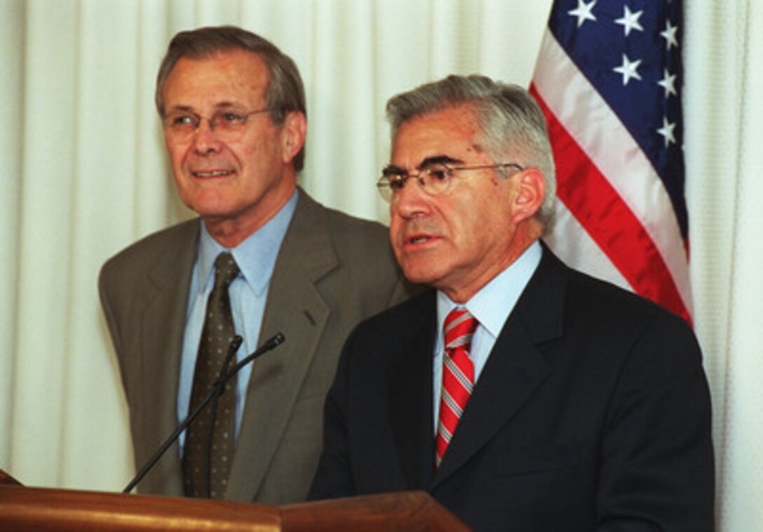 Following their meeting at the Pentagon on May 24, 2001, Secretary of Defense Donald H. Rumsfeld (left) and Minister of Defense Mario Fernandez of the Republic of Chile (right) take questions from news reporters. Fernandez, in Washington, D. C., to deliver the keynote address at the Seminar on Research and Education in Defense and Security Studies being held at the National Defense University, used the opportunity to stop by the Department of Defense to discuss some issues of mutual interest with Rumsfeld. Chile's planned purchase of U.S. F-16 fighter aircraft was one of several topics they discussed. 