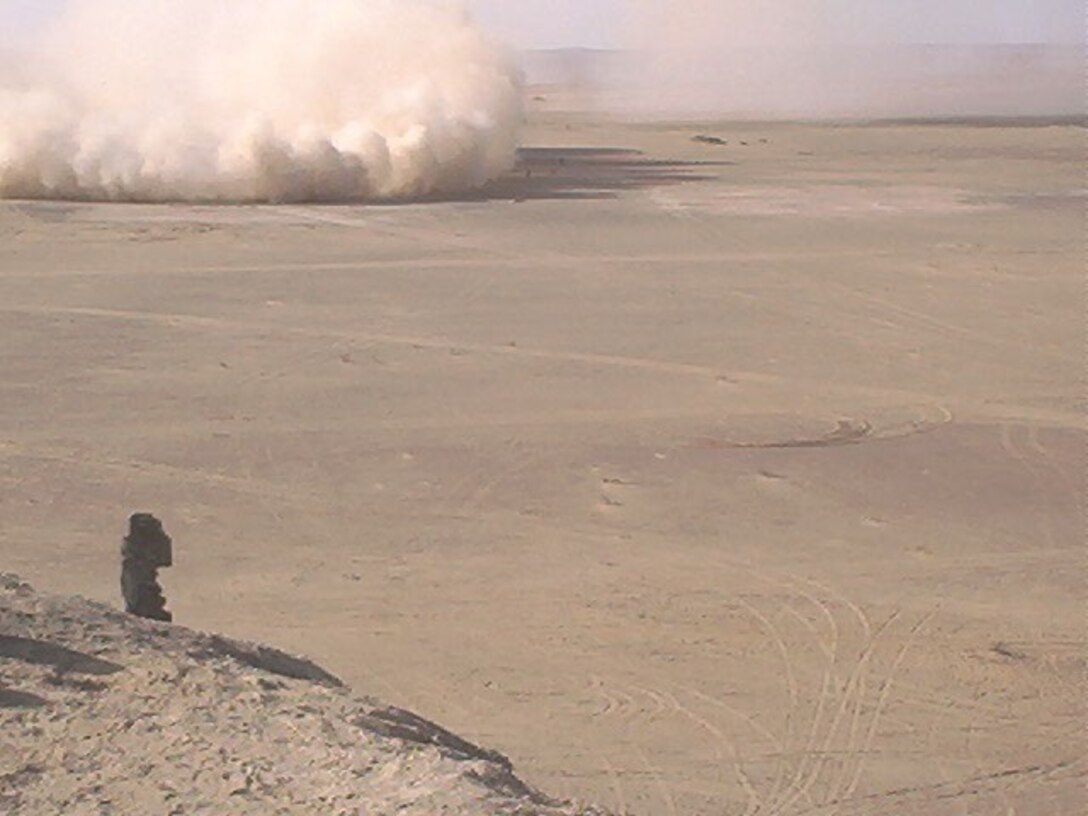 In a cloud of dust, a CH-53E Super Stallion lands in Camp Rhino, Afghanistan in November 2001. Lt. Col. Alison Thompson, the commanding officer of Marine Heavy Helicopter Squadron of HMH-464, served as a CH-53E pilot with Task Force 58 during the initial invasion of Afghanistan in 2001.